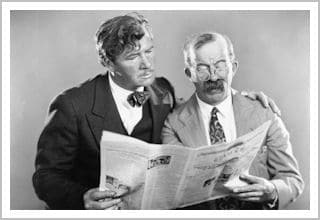 Two guys reading the newspaper